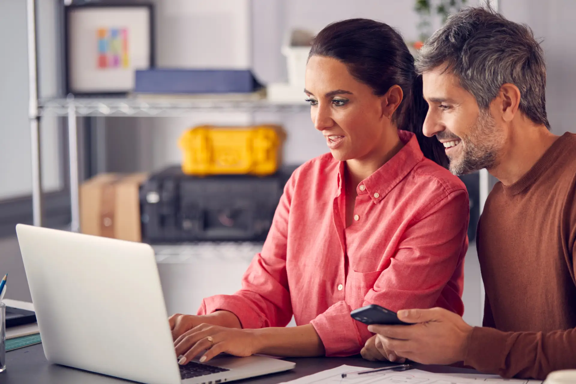 Two small business owners learning at a laptop together