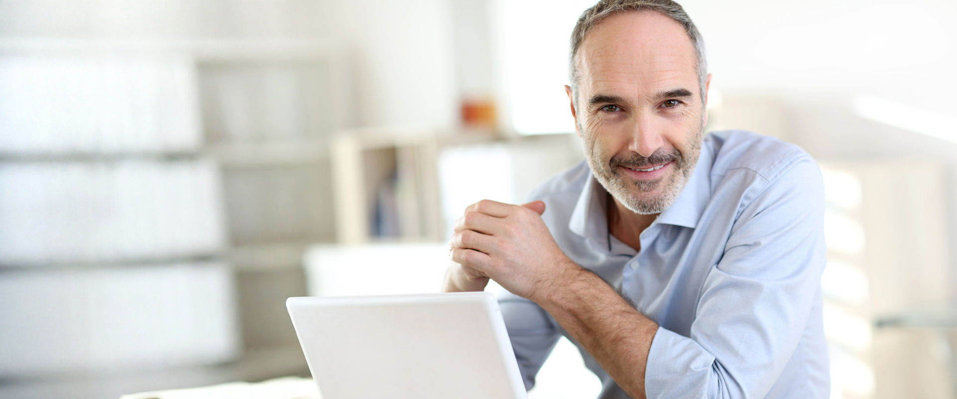 business owner smiling at his desk